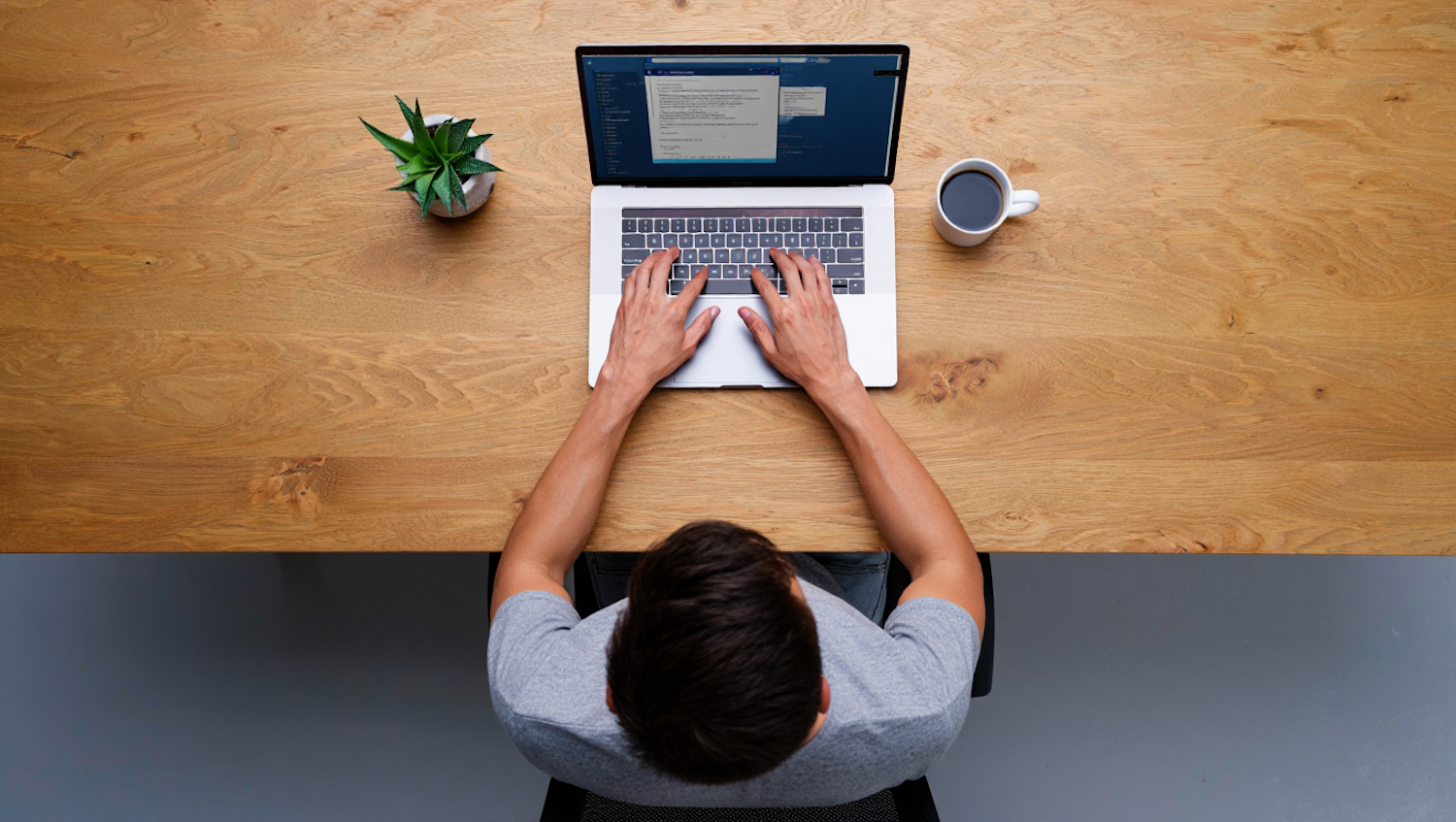 A person intently looking at a laptop screen, researching medical sales job opportunities and company information online.